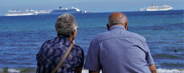 Older couple sitting at beach